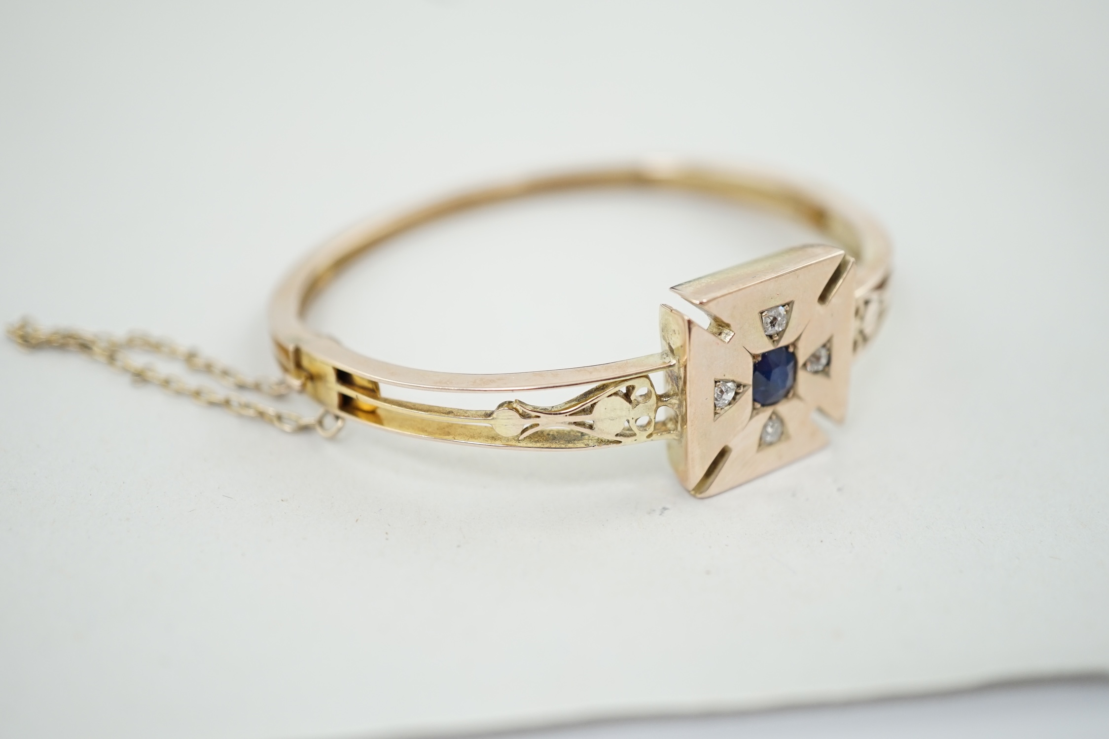 A Victorian gold, single stone sapphire and four stone diamond set hinged bracelet